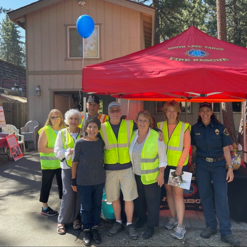 Photo credit: Tahoe RCDCaption: City of South Lake Tahoe Fire and Rescue’s Battalion Chief Kim George with Firewise community members at a workday event.